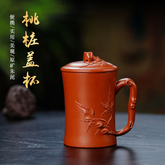 Handmade Yixing purple sand tea cup with lid, featuring intricate floral design, perfect for tea enthusiasts.