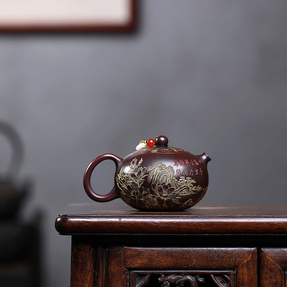 Handmade Yixing purple sand teapot featuring intricate floral engravings, perfect for kung fu tea rituals.