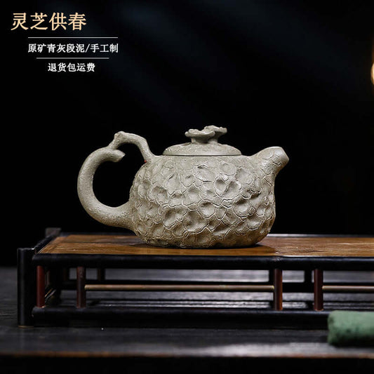 Handmade Yixing purple sand teapot with floral design, crafted from original green ash section mud for tea enthusiasts.