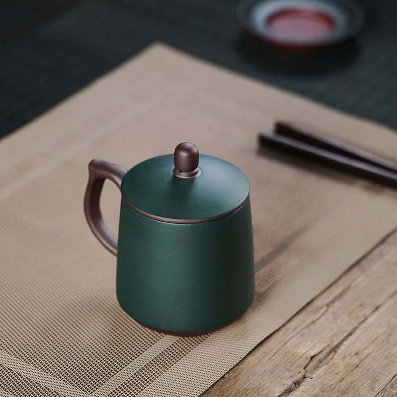 Handmade Yixing purple sand cup, green with brown lid, ideal for tea lovers and perfect for gifting to elders.