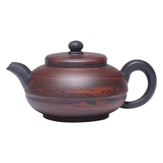 Handmade Yixing purple sand teapot with intricate wood-like patterns and a traditional silhouette.