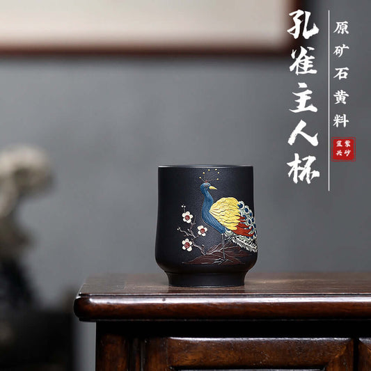 Handmade Yixing purple sand tea cup with peacock design, crafted from original yellow mud, perfect for kung fu tea sets.