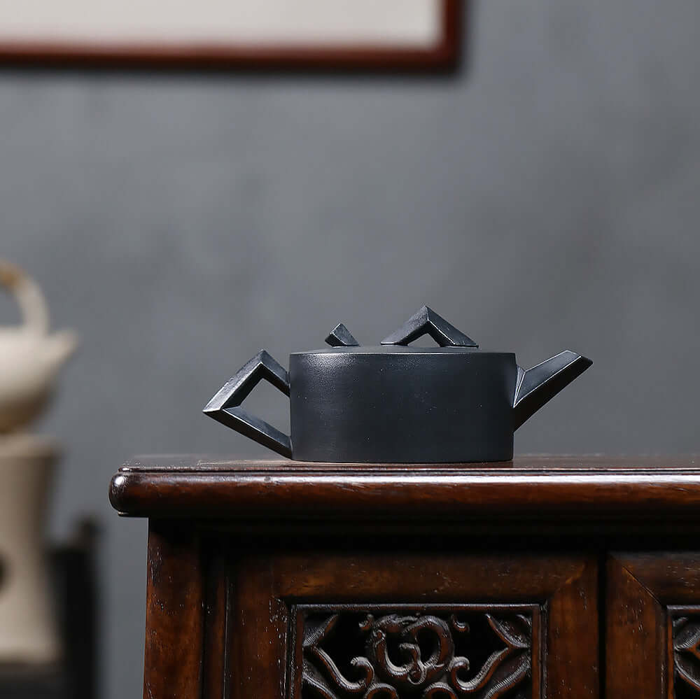 Handmade Yixing purple sand teapot featuring a geometric design, ideal for kung fu tea ceremonies.