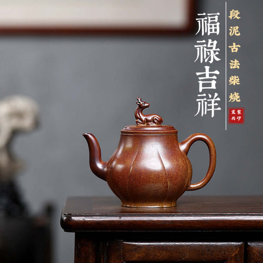 Handmade Yixing purple sand teapot featuring ancient method craftsmanship, showcasing unique design and auspicious motifs.