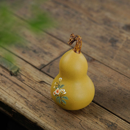 Handmade Yixing purple sand tea pet gourd sculpture with floral design, crafted from original purple sand.