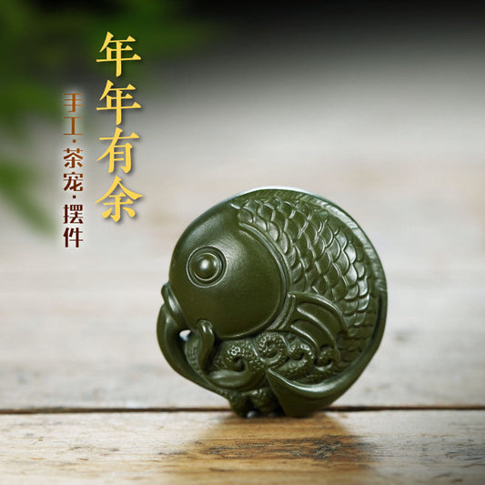 Handmade Yixing purple sand fish ornament, showcasing exquisite craftsmanship for tea table decor.
