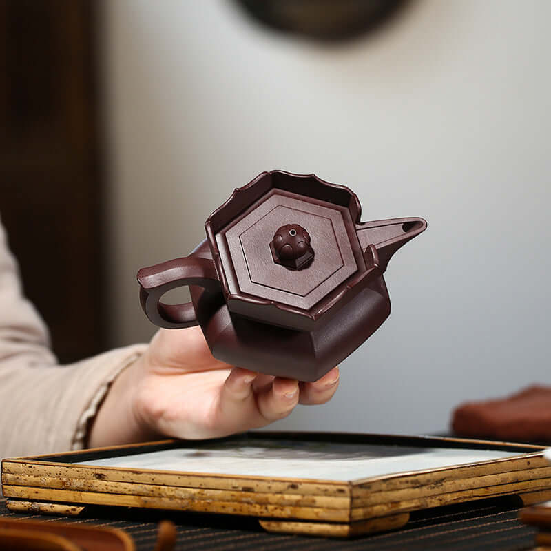 Handmade Yixing purple sand teapot with a unique octagonal design, perfect for tea enthusiasts and collectors.