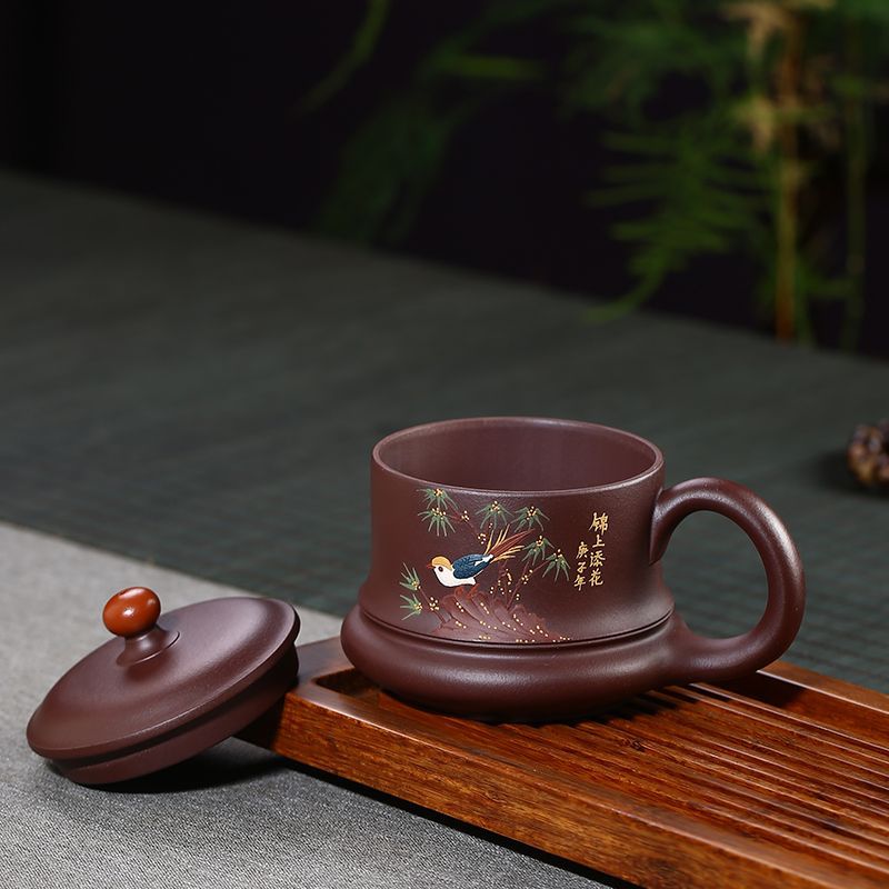 Handmade Yixing purple sand teacup with floral and bird painting, featuring a round lid and comfortable handle.