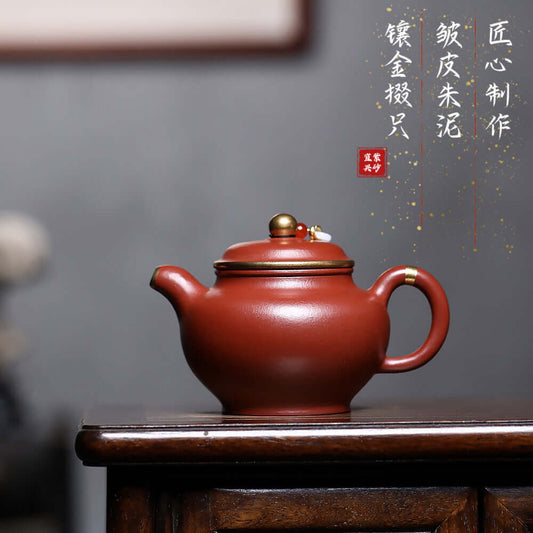 Handmade Yixing purple sand teapot with gold inlay, featuring a unique mineral wrinkled surface for Kung Fu tea sets.