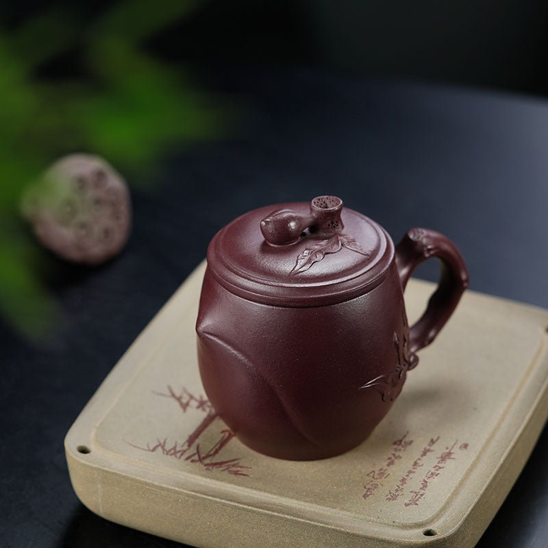Handmade Yixing purple sand cup with lid, showcasing fine craftsmanship, perfect for tea lovers.