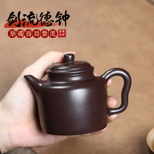 Handmade Yixing purple sand teapot, crafted by skilled artisans, perfect for Kung Fu tea sets and tea enthusiasts.