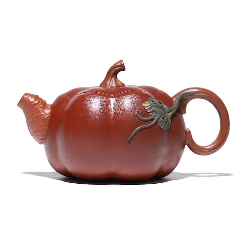 Handmade Yixing purple sand teapot in pumpkin shape with detailed handle resembling a vine and decorative lid.