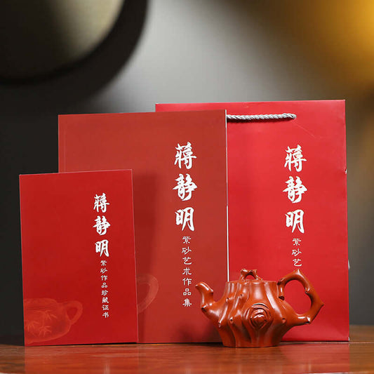 Handmade Yixing purple sand teapot with packaging, showcasing traditional craftsmanship and elegant design.