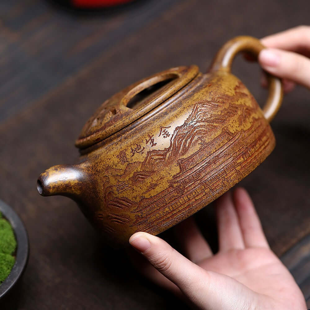 Handmade Yixing purple sand teapot with unique engraving, large capacity for tea, crafted by skilled artisans.
