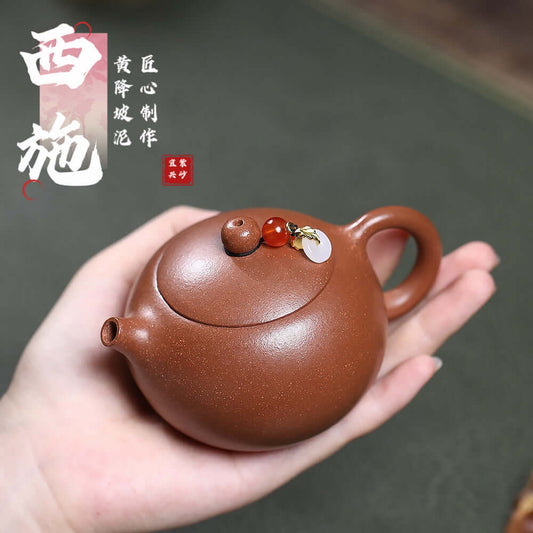 Handmade Yixing purple sand teapot with decorative elements, ideal for home Kung Fu tea ceremonies.
