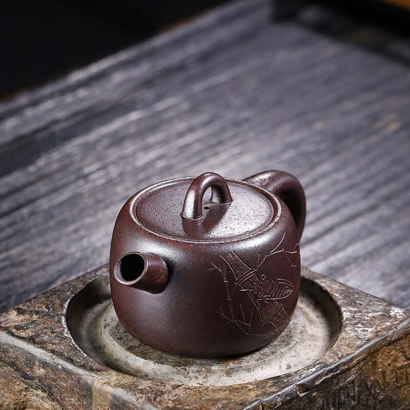 Handmade Yixing purple sand teapot featuring a unique design, showcasing craftsmanship and traditional tea culture.