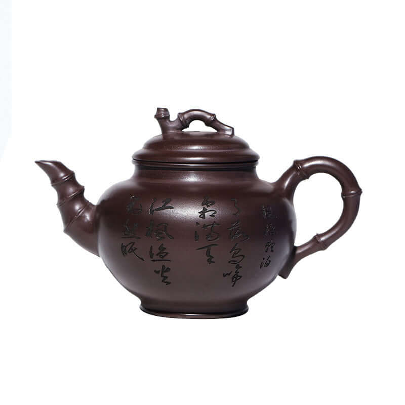 Handmade Yixing purple sand teapot with elegant bamboo design and calligraphy, showcasing traditional craftsmanship.