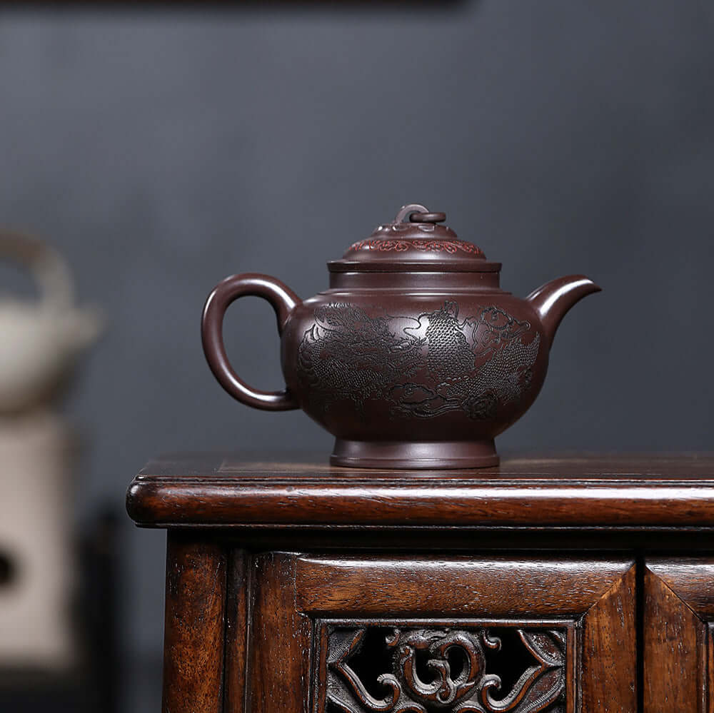 Handmade Yixing purple sand teapot with intricate design, perfect for kung fu tea sets and showcasing craftsmanship.