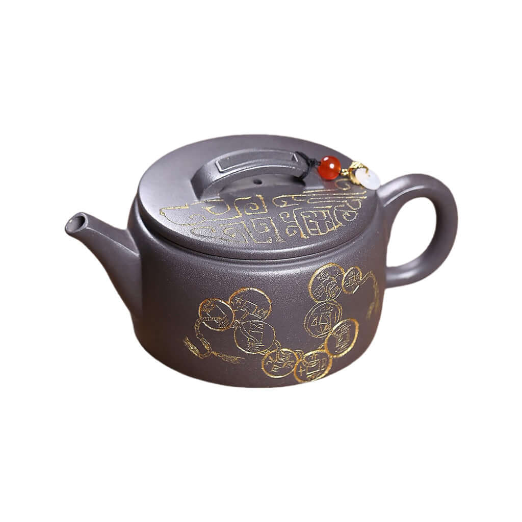 Handmade Yixing purple sand teapot featuring gold detailing, crafted for Kung Fu tea sets and tea lovers.