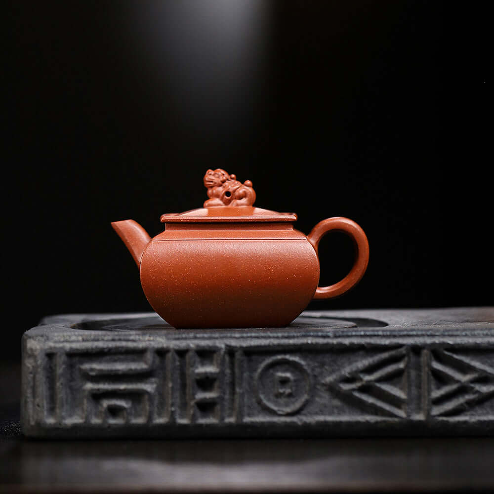 Handmade Yixing purple sand teapot with lion design, showcasing artisanal craftsmanship for tea enthusiasts.