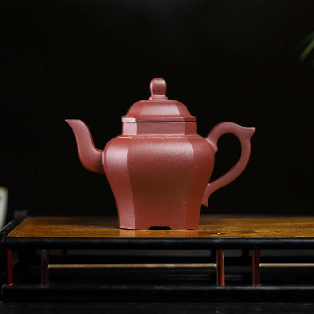 Handmade Yixing purple sand teapot in a square shape, showcasing fine craftsmanship and elegant design.