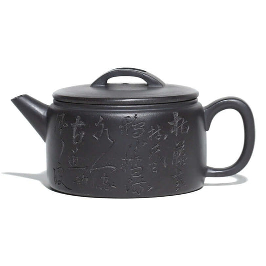 Handmade Yixing purple sand teapot with intricate carvings and a sturdy handle, showcasing traditional craftsmanship.