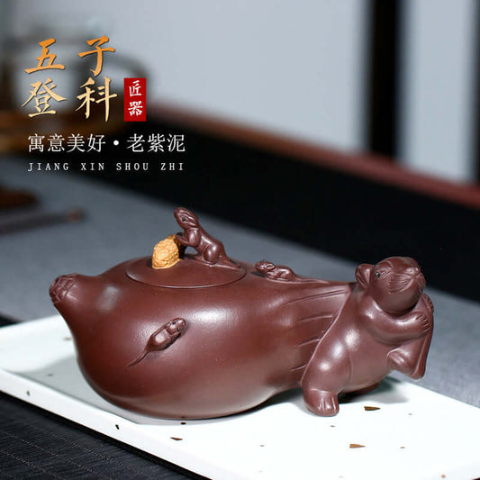 Handmade Yixing purple sand teapot featuring a playful mouse design, crafted by Jiang Xin Shou Zhi, symbolizing good fortune.