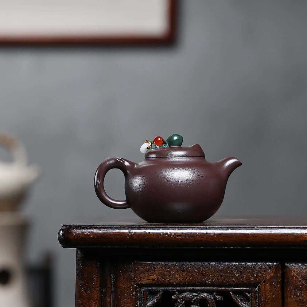 Handmade Yixing purple sand teapot with intricate lid details, perfect for Kung Fu tea ceremonies.