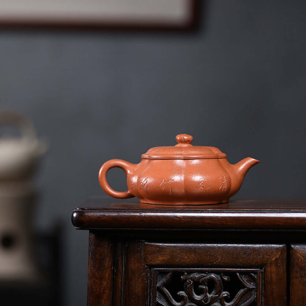 Handmade Yixing purple sand teapot displayed on wooden table, showcasing craftsmanship and original design.
