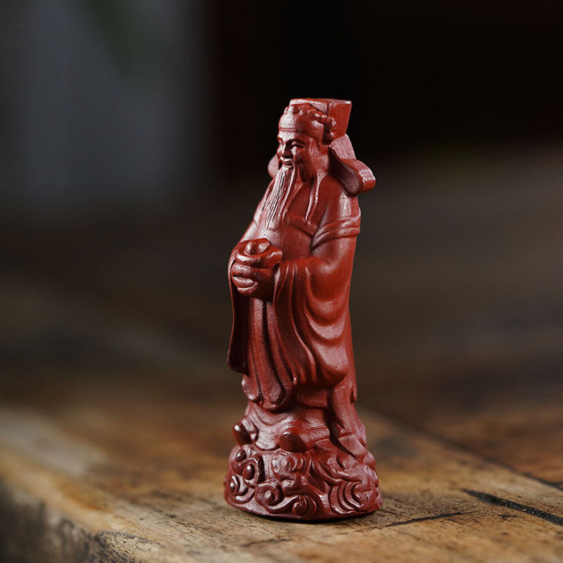 Handmade purple clay God of Wealth ornament in red robe, Yixing craftsman art, perfect for tea set decoration.