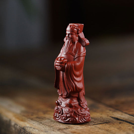 Handmade purple clay God of Wealth ornament in red robe, Yixing craftsman art, perfect for tea set decoration.