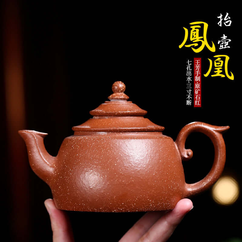 Handmade Yixing purple sand teapot with a unique design, crafted by Wang Xinhong, showcasing a traditional phoenix style.