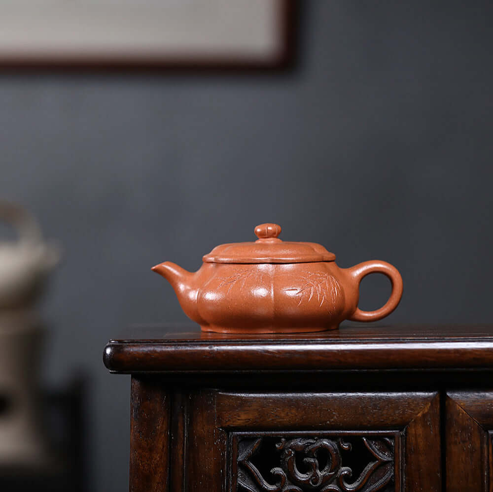 Handmade Yixing purple sand teapot with a pumpkin shape, perfect for kung fu tea ceremonies.