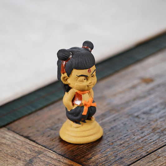 Handmade purple sand Nezha tea pet ornament by Yixing craftsman, perfect for tea lovers and collectors.