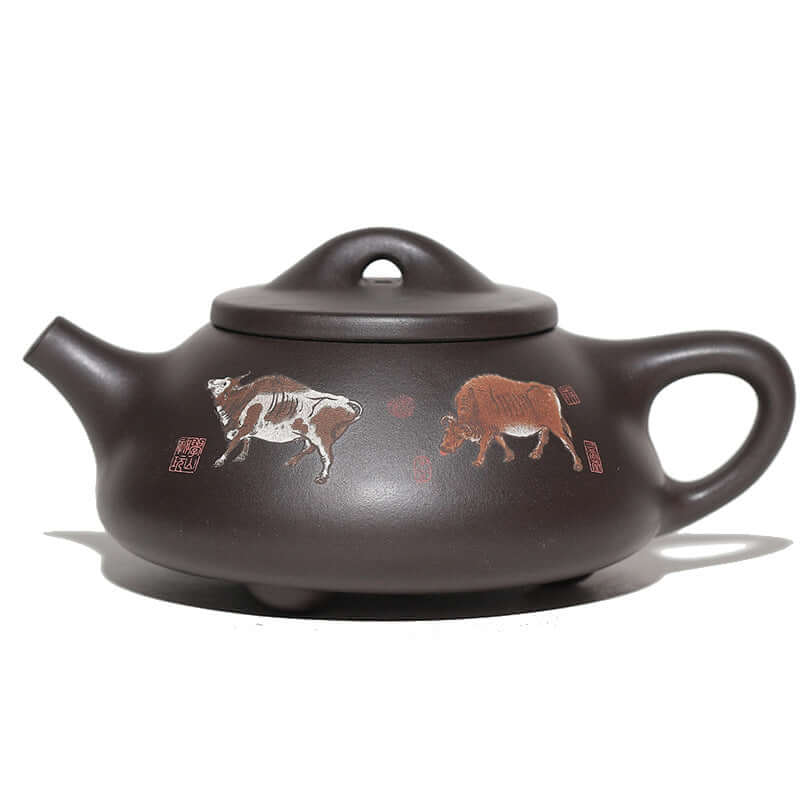 Handmade Yixing purple sand teapot with cow designs, showcasing traditional Chinese craftsmanship.