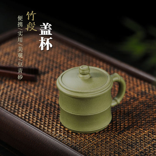 Handmade Yixing purple sand cup with bamboo cover for tea steeping and water separation, ideal for office use.