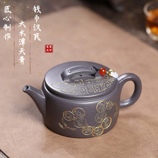 Handmade Yixing purple sand teapot with gold coin design, perfect for Kung Fu tea sets and tea enthusiasts.