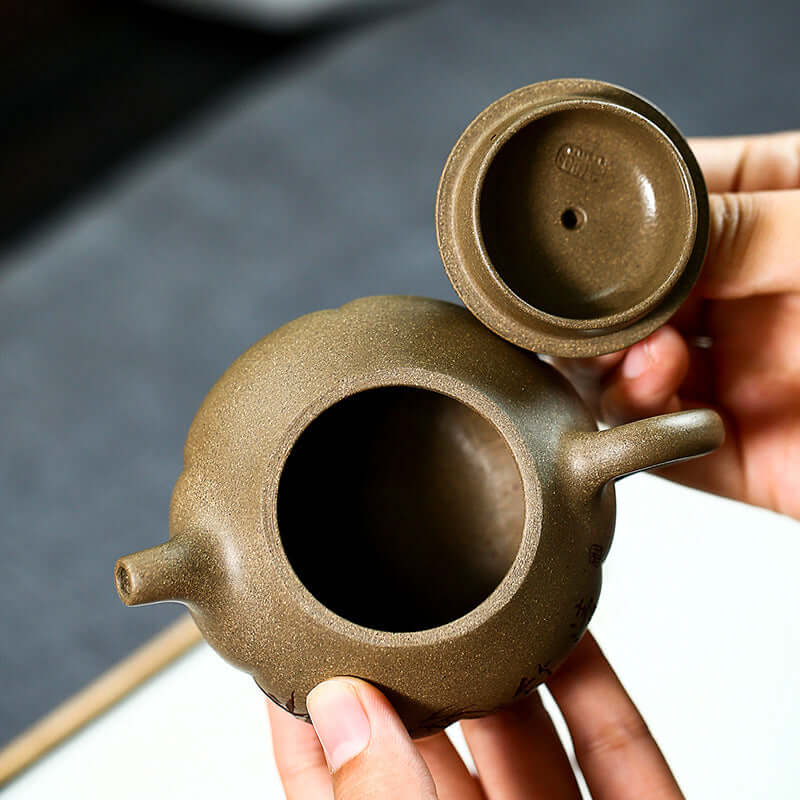 Handmade Yixing purple sand teapot showcased with lid, highlighting craftsmanship and unique design.