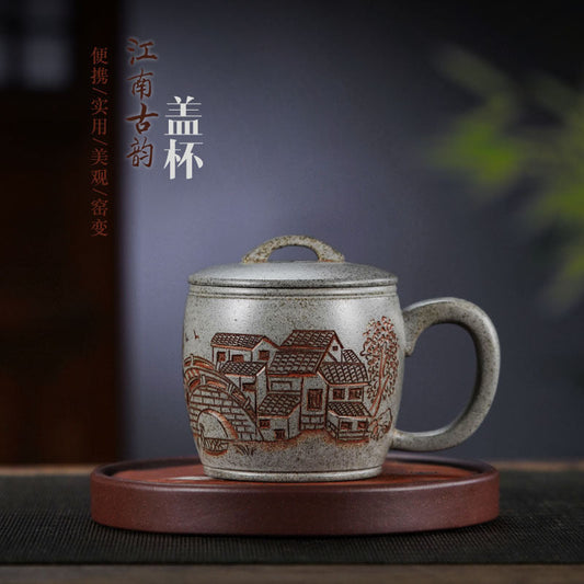 Handmade Yixing purple sand tea mug featuring intricate Jiangnan design with a lid, crafted by skilled artisans.