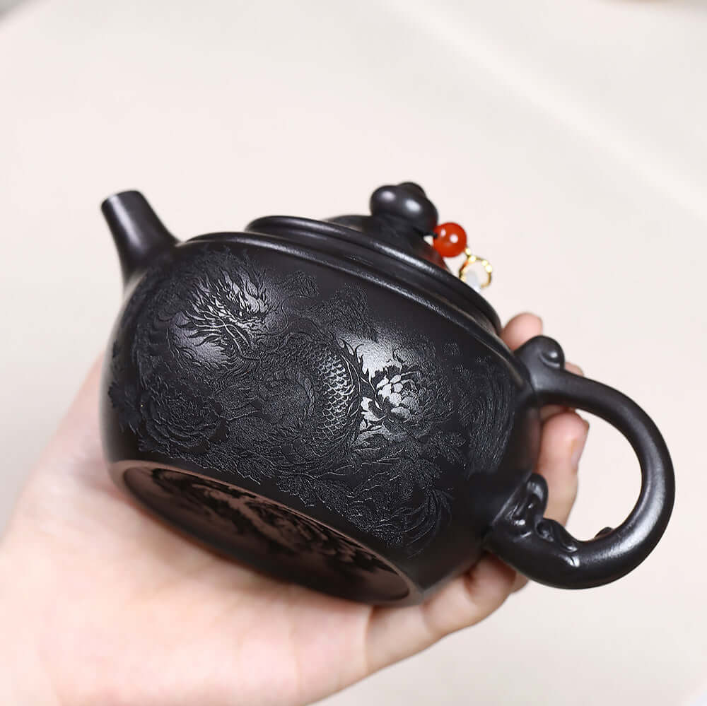 Handmade Yixing purple sand teapot with dragon design, original mineral black iron stone, perfect for Kung Fu tea sets.