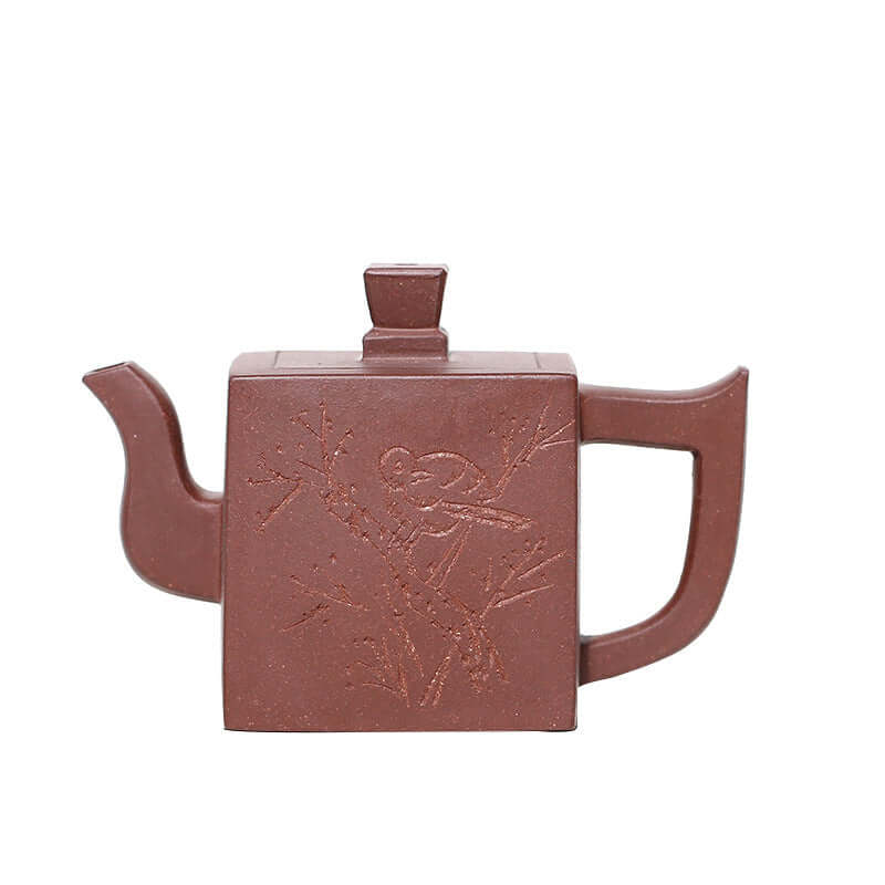 Handmade Yixing purple sand teapot with engraved bird design and square shape, ideal for tea lovers.