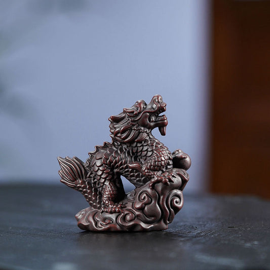 Handmade Yixing purple sand Xiangyun dragon tea pet ornament for tea ceremonies and home decor.
