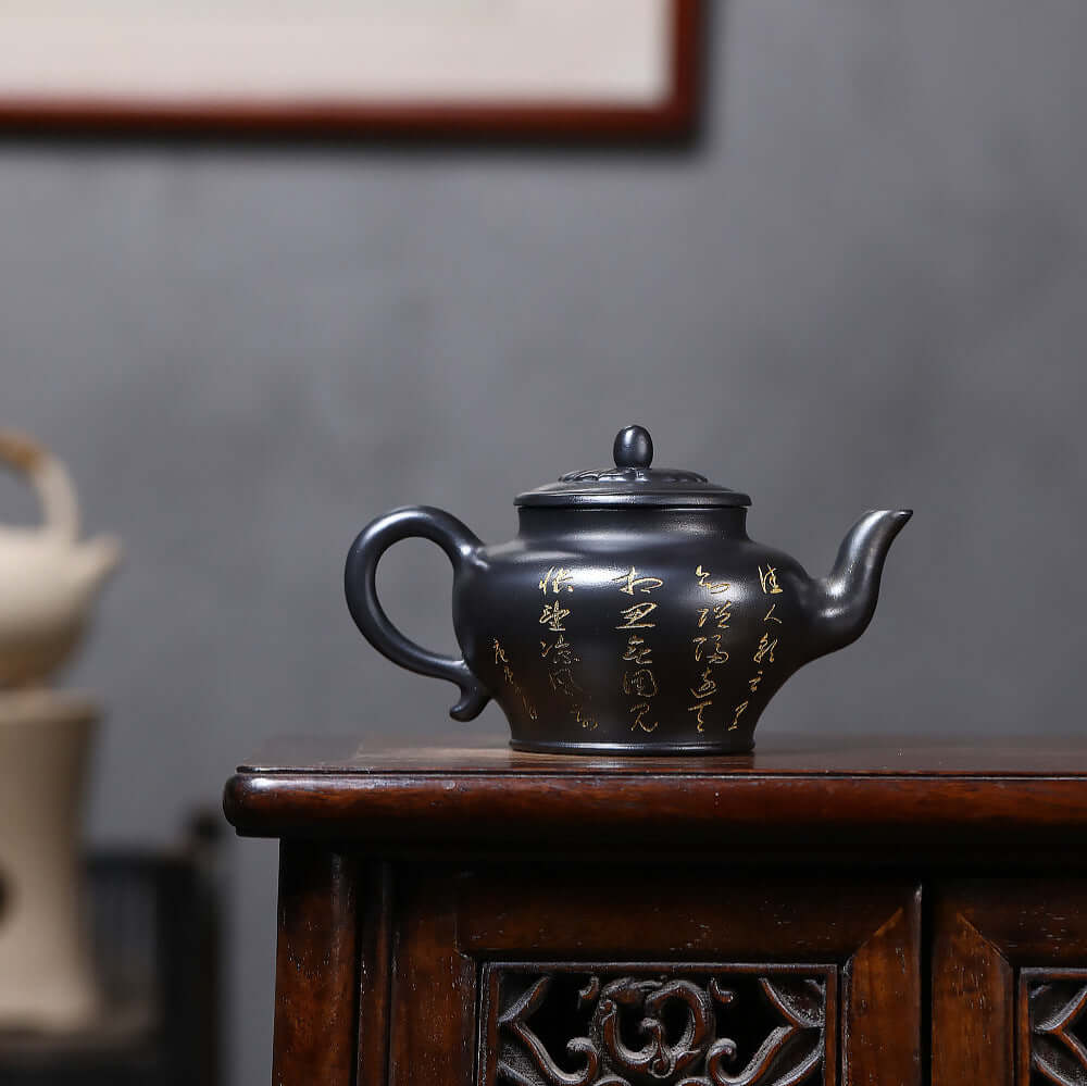 Handmade Yixing purple sand teapot with gold inscriptions, perfect for Kung Fu tea ceremonies and home use.