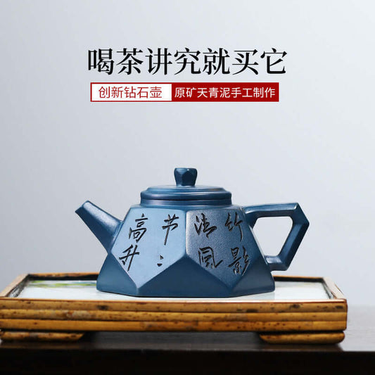 Handmade Yixing purple sand teapot in diamond shape with inscriptions, showcasing unique craftsmanship and elegant design.