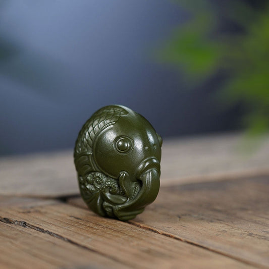 Handmade Yixing purple sand tea pet, green mud fish ornament, crafted by Yixing artisans, perfect for tea table decor.
