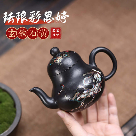 Handmade Yixing purple sand teapot crafted from raw ore black iron stone with intricate enamel designs.