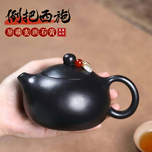 Handmade Yixing purple sand teapot with yellow inverted handle, crafted by Yixing artisans for Kung Fu tea sets.