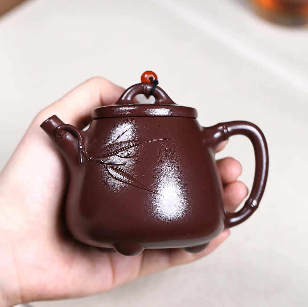 Handmade Yixing purple sand teapot featuring bamboo design, perfect for Kung Fu tea set and home brewing.