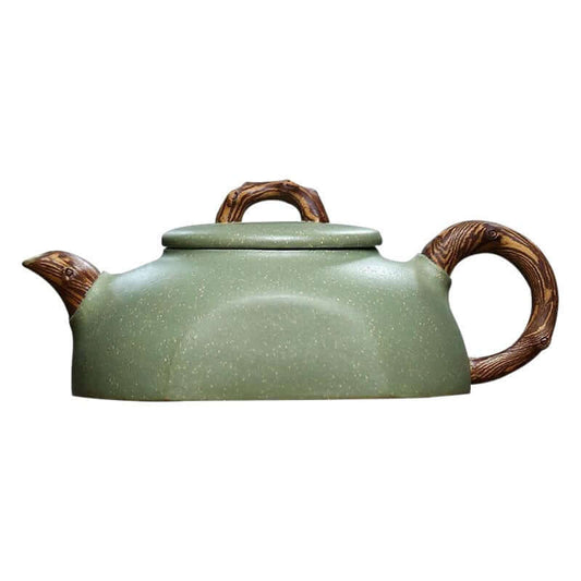 Handmade Yixing purple sand teapot with a green finish, featuring a textured handle resembling tree branches.