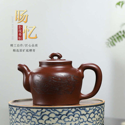 Handmade Yixing purple sand teapot with intricate design, showcasing fine craftsmanship and elegant shape.